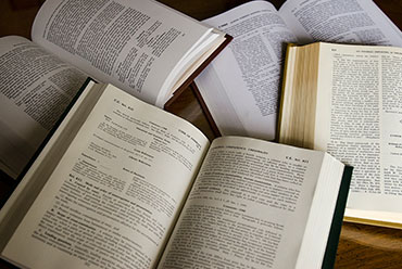 Open law books with pages filled with text.