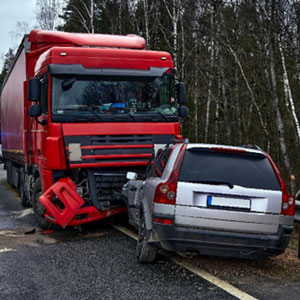 A truck and a car collide on the road, illustrating a crash. This image relates to Louisiana Commercial Trucking Claims 101 - Whitley-Sebti Law