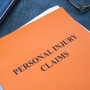 Personal Injury Claims file on desk, representing legal documentation for injury cases