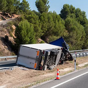 Overturned truck on the highway illustrating the impact of truck accidents on legal claims